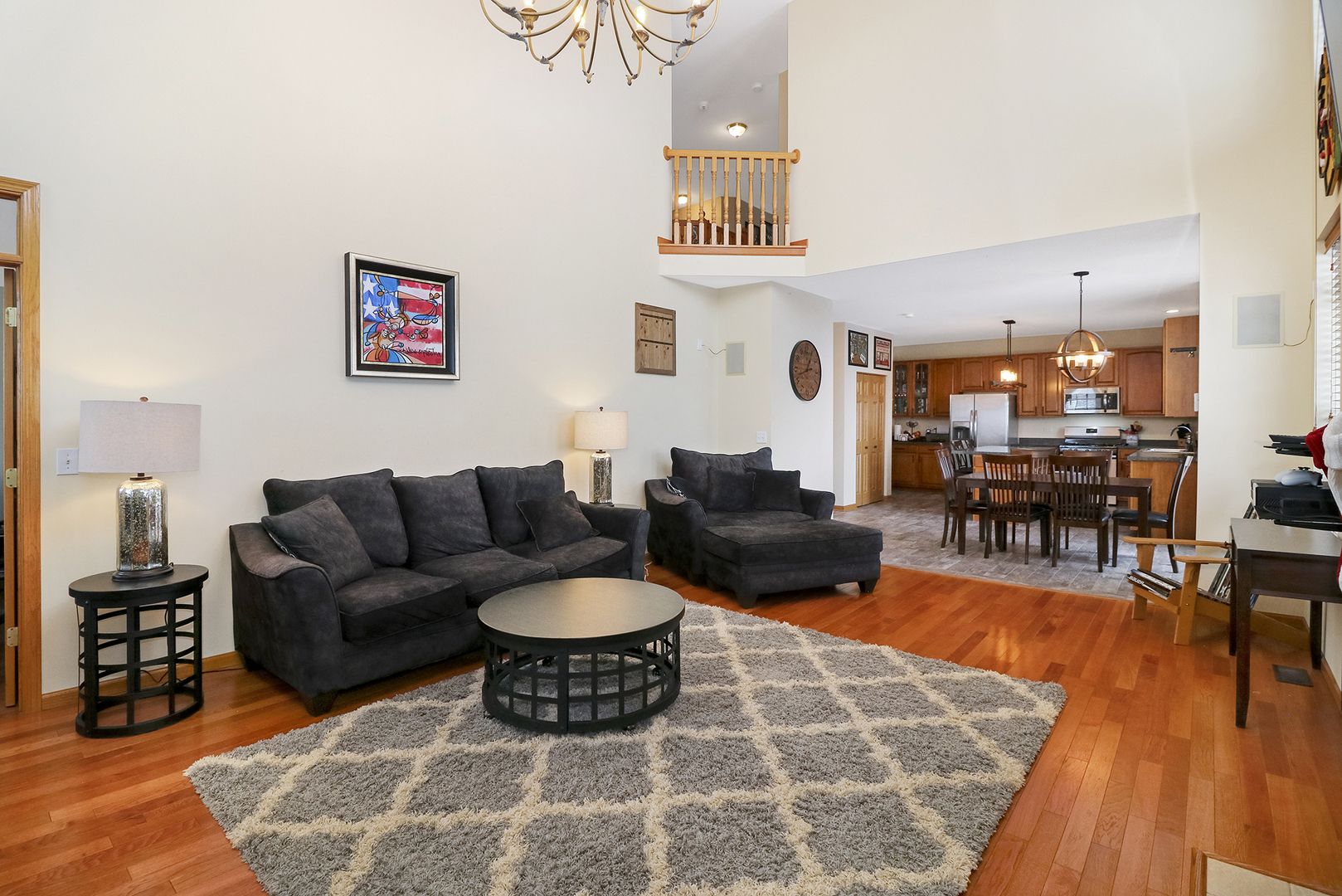 428 Cardinal Lane Bolingbrook, IL 60490 - Photo 21 of 36 a living room with furniture and a dining table with wooden floor
