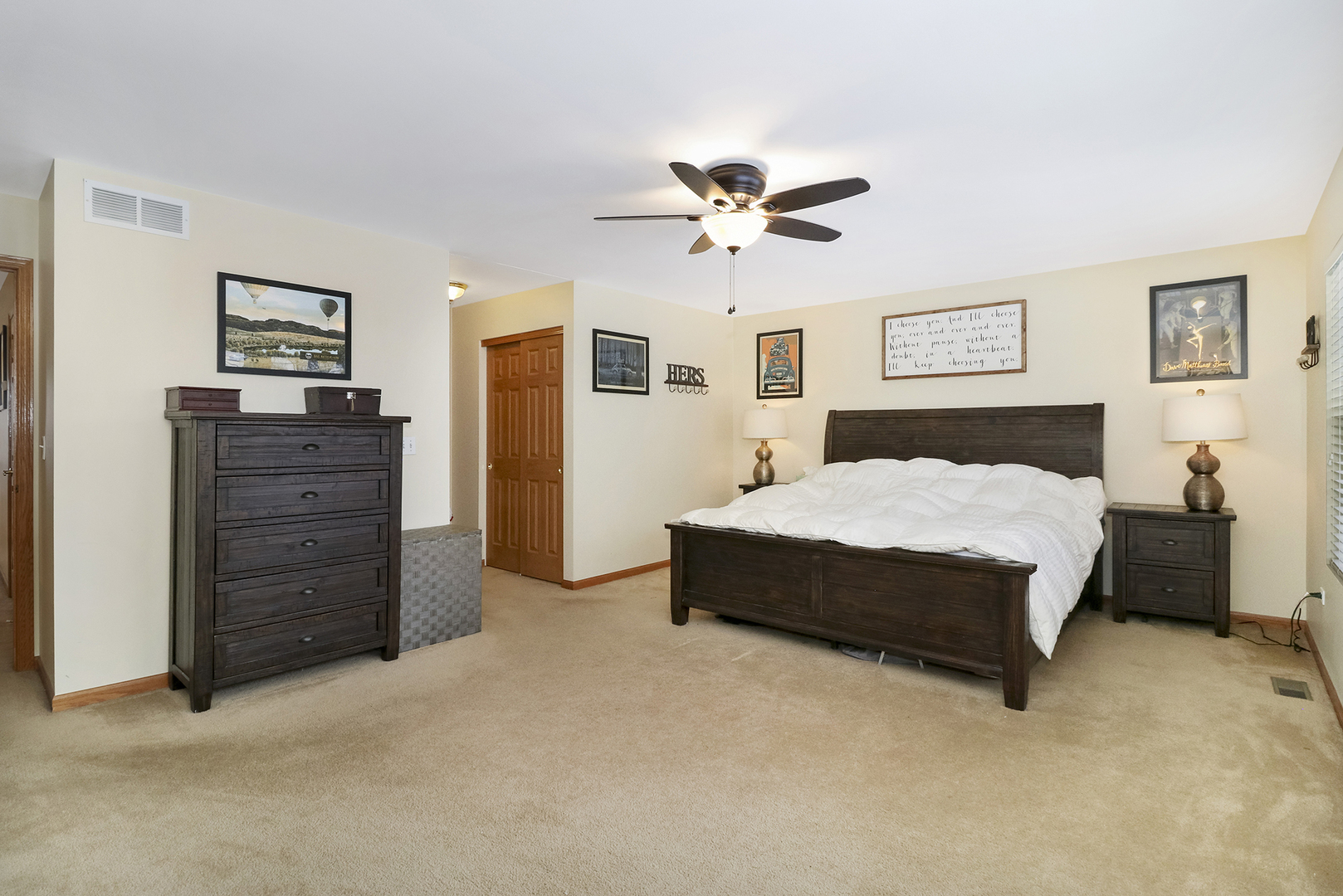428 Cardinal Lane Bolingbrook, IL 60490 - Photo 32 of 36 a spacious bedroom with a bed a dresser and a painting