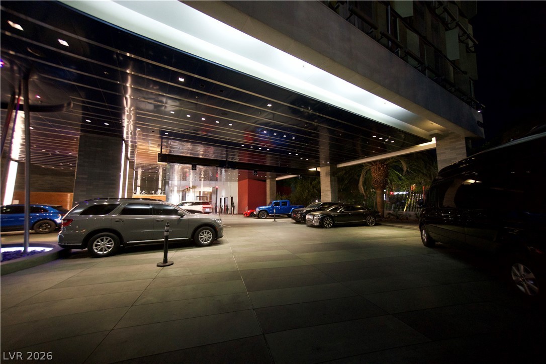 4381 West Flamingo Road, Unit 3616 Las Vegas, NV 89103 - Photo 25 of 29 A grand porte-cochere welcomes with sleek architecture and sophisticated evening illumination.