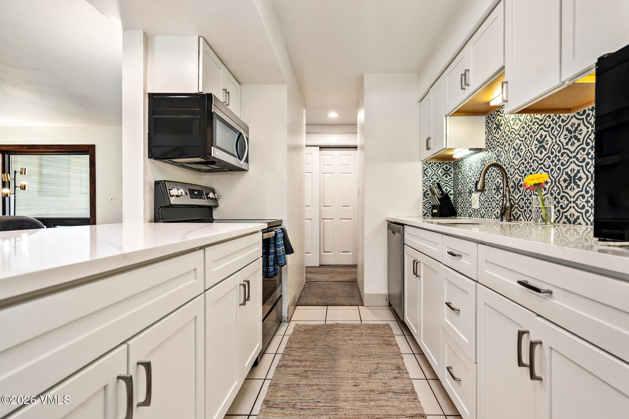 963 Lions Ridge Loop, Unit 502 Vail, CO 81657 - Photo 9 of 30 a kitchen with stainless steel appliances microwave and stove
