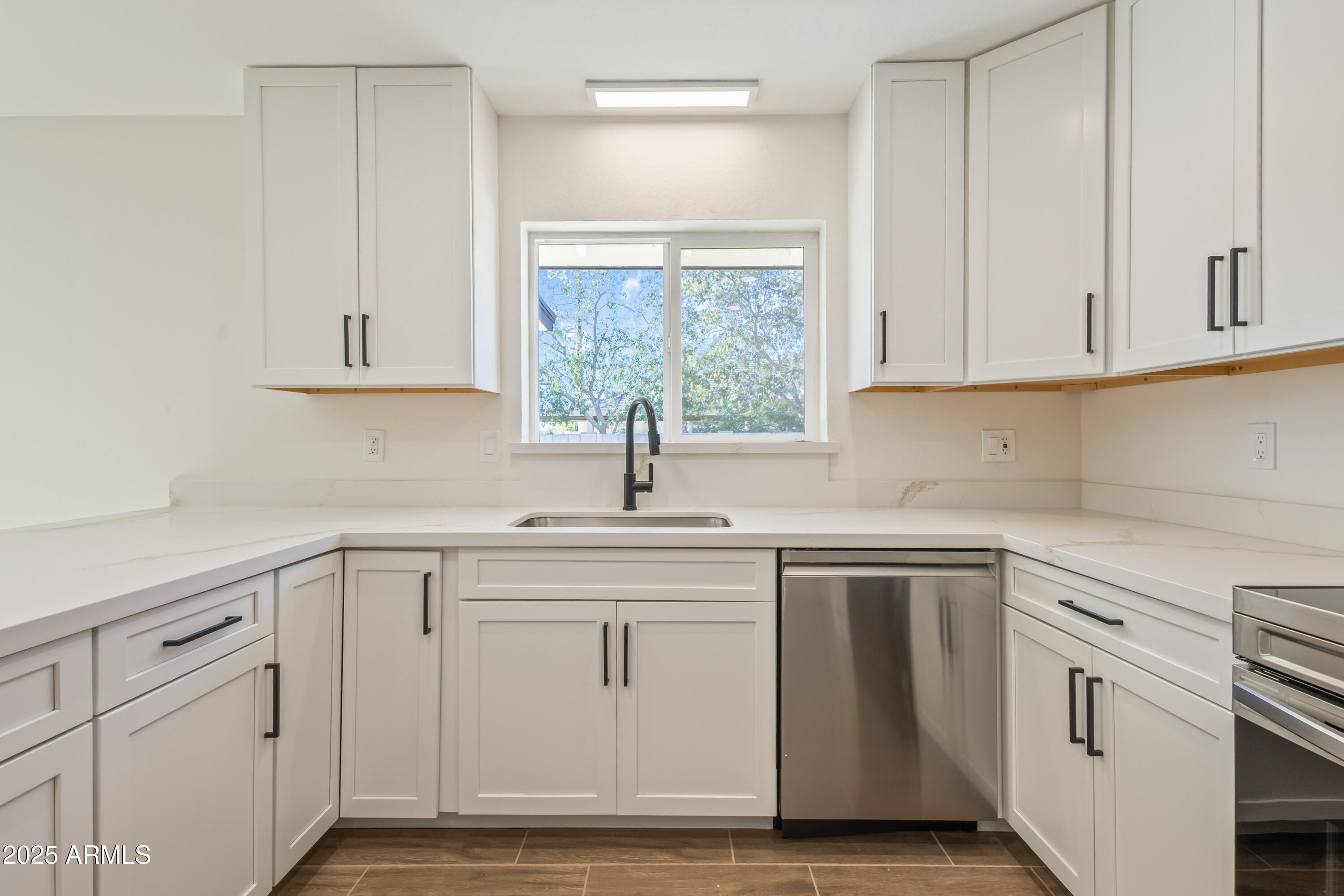 1022 South Allen Mesa, AZ 85204 - Photo 13 of 38 a kitchen with white cabinets white appliances and sink