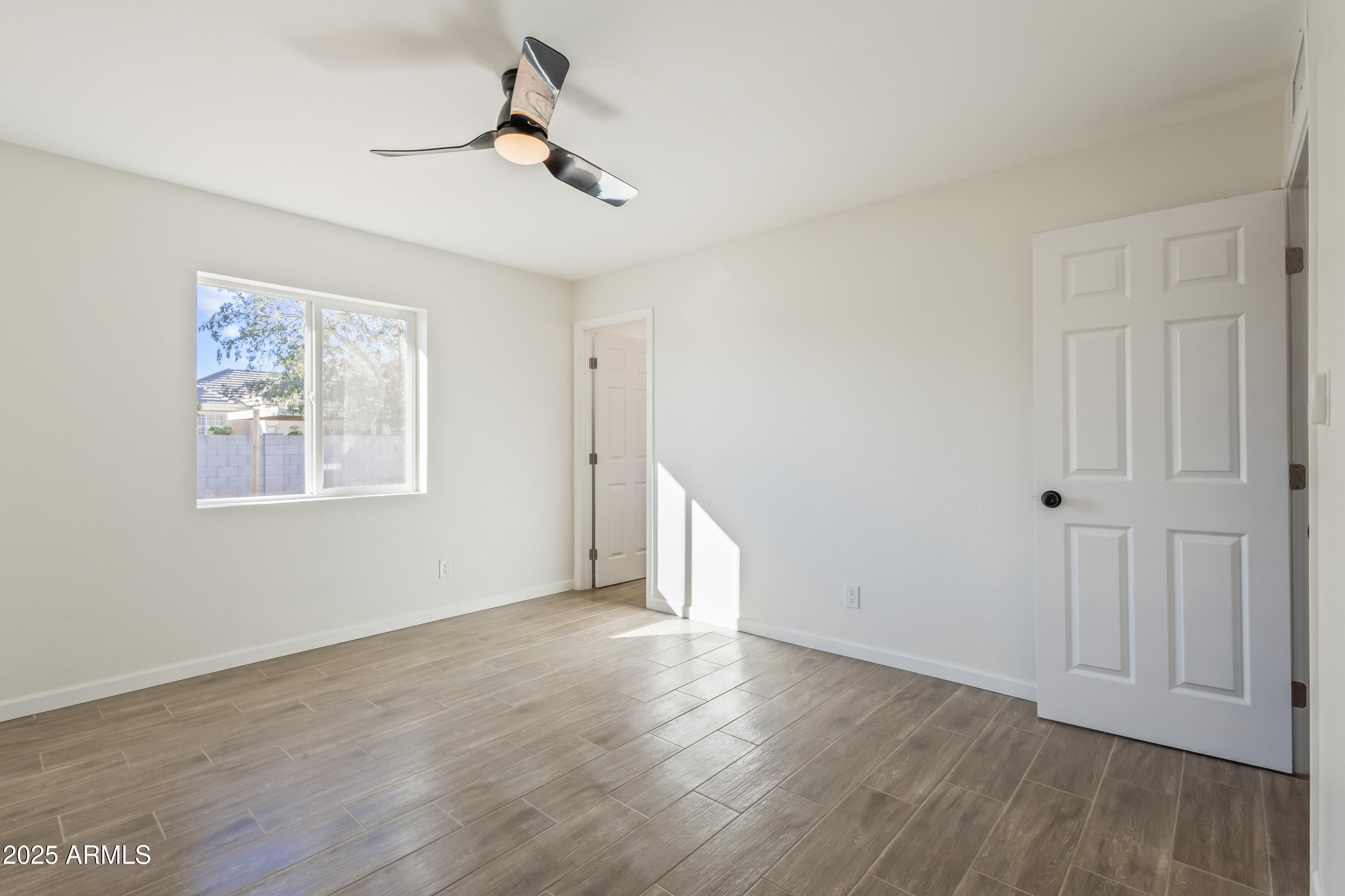 1022 South Allen Mesa, AZ 85204 - Photo 19 of 38 a view of an empty room with wooden floor and a window