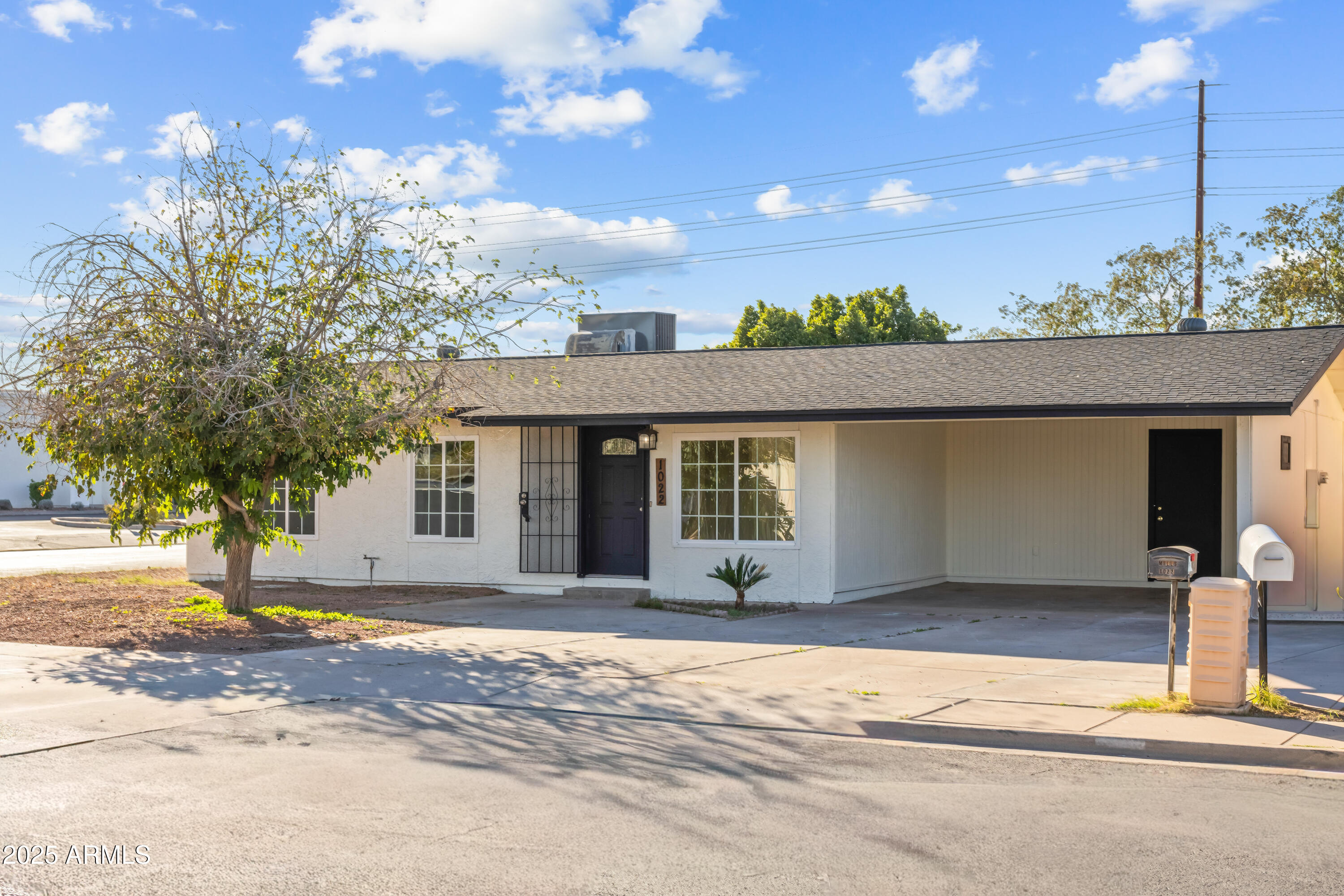 1022 South Allen Mesa, AZ 85204 - Photo 2 of 38 a front view of a house with a yard and potted plants