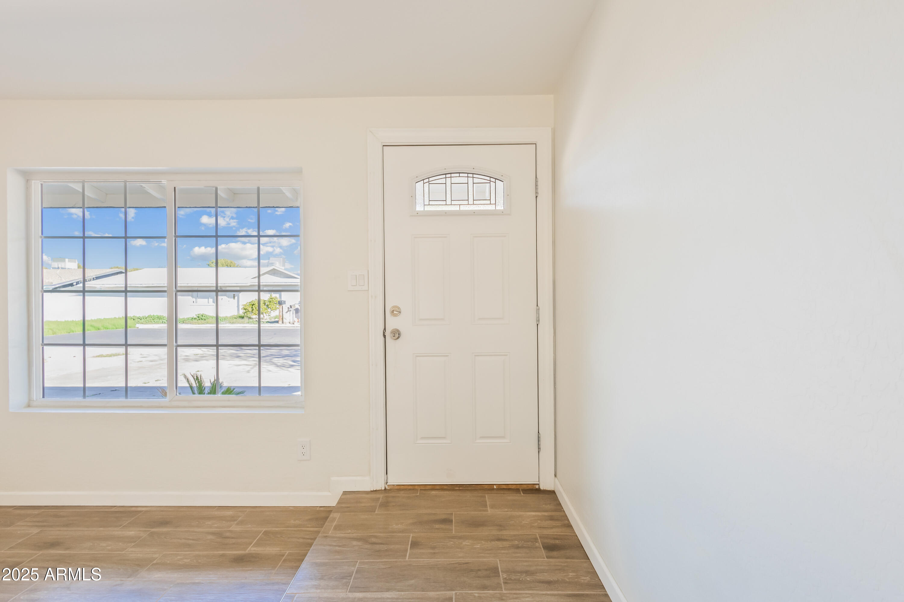 1022 South Allen Mesa, AZ 85204 - Photo 6 of 38 a view of an empty room with wooden floor and a window