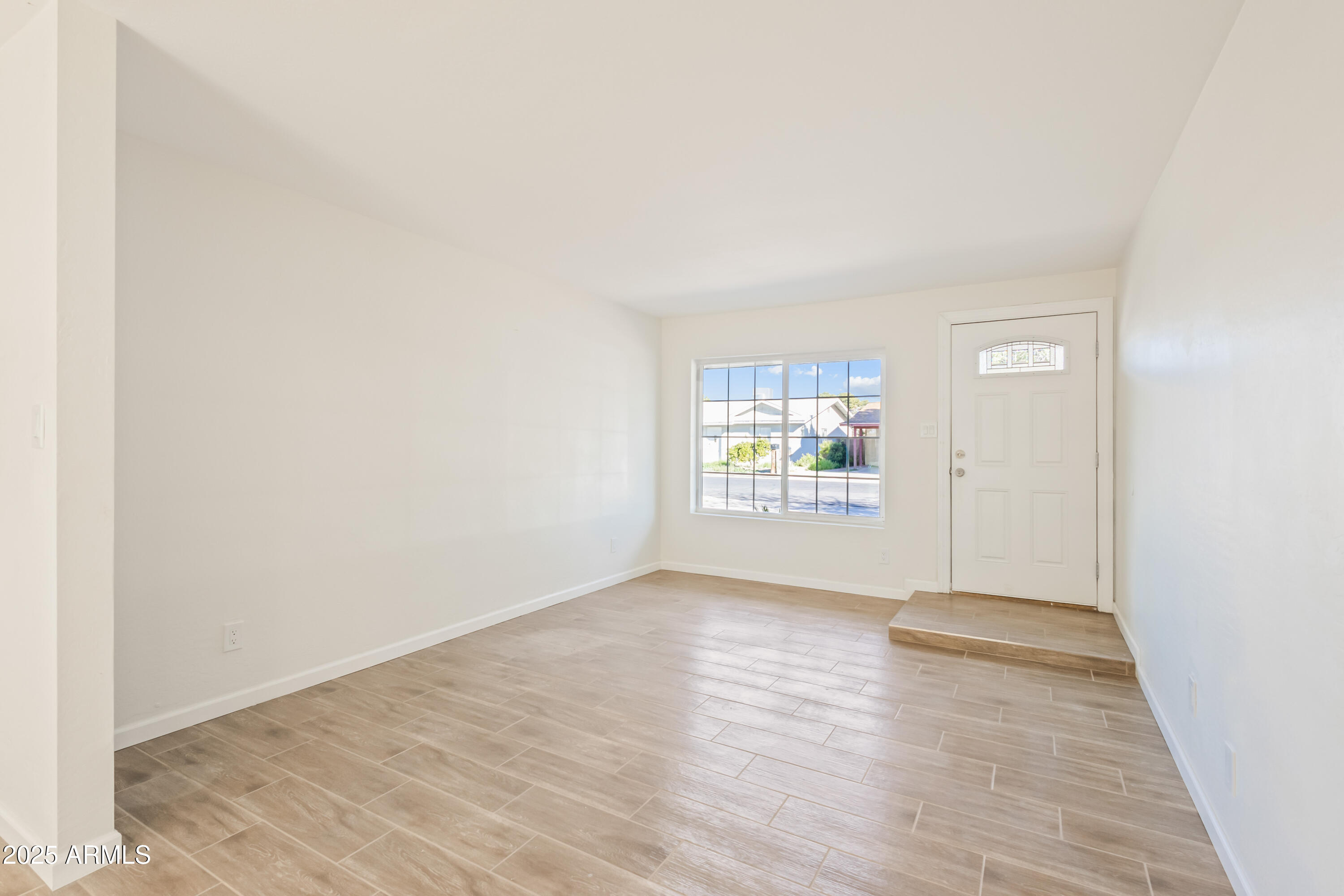 1022 South Allen Mesa, AZ 85204 - Photo 7 of 38 an empty room with wooden floor and windows