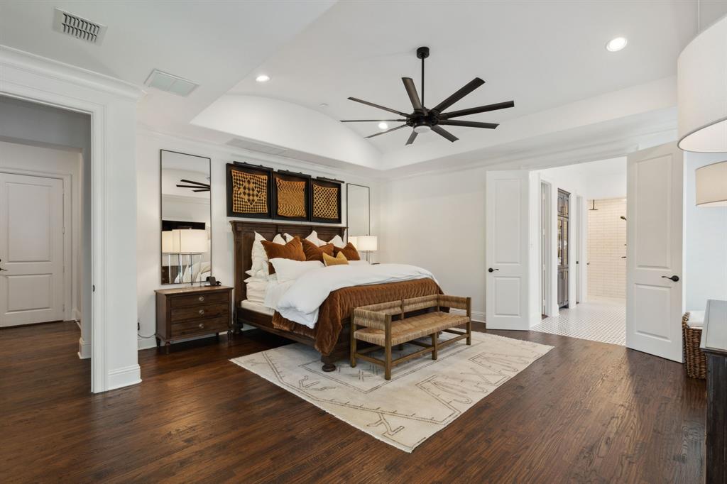 12444 Riverhill Road Frisco, TX 75033 - Photo 18 of 37 Master Bedroom with a raised ceiling, crown moulding, ceiling fan, and hardwood flooring.