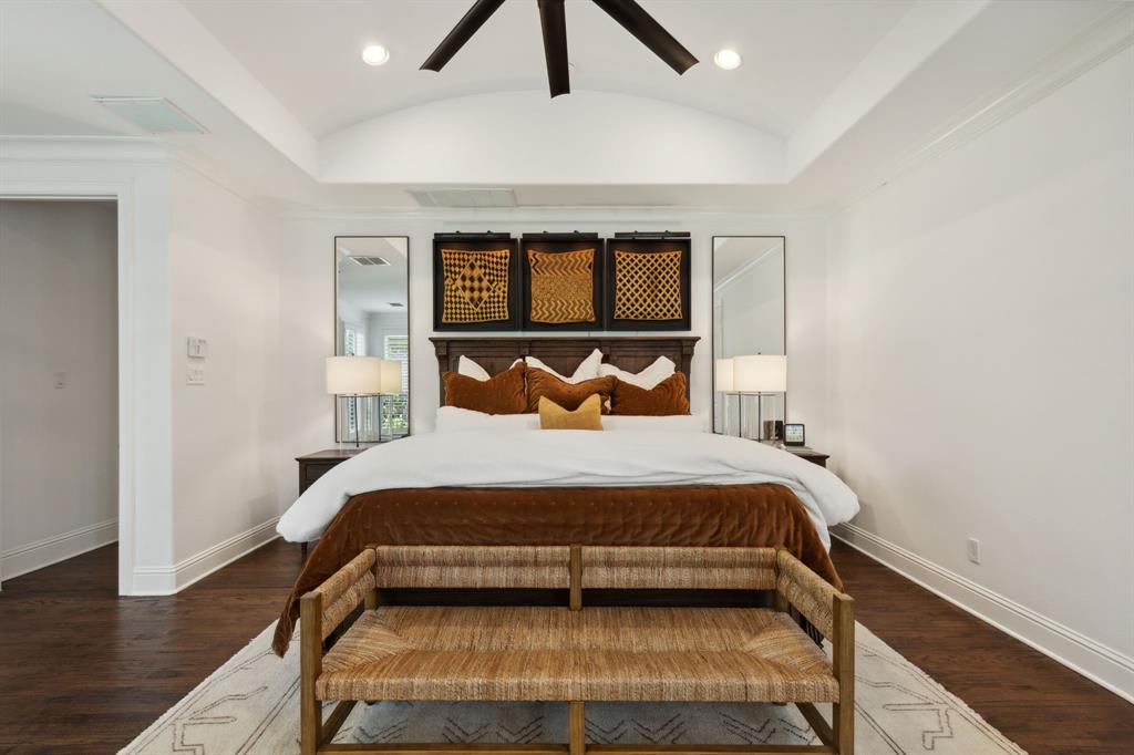 12444 Riverhill Road Frisco, TX 75033 - Photo 19 of 37 MasterBedroom featuring hardwood floors, ceiling fan, and vaulted ceiling.
