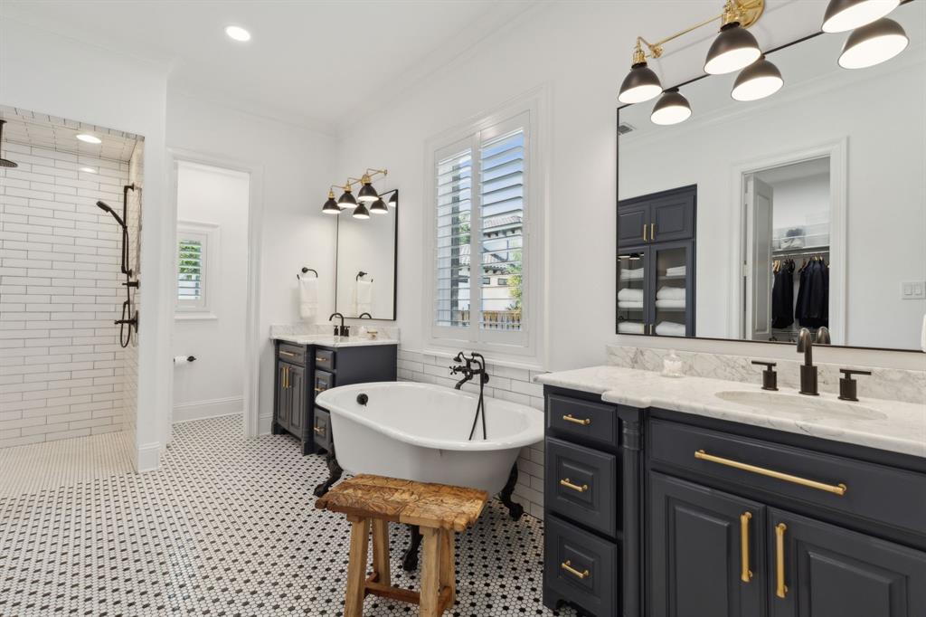 12444 Riverhill Road Frisco, TX 75033 - Photo 21 of 37 Master Bathroom featuring a tile shower, dual vanities with marble tops, custom metal wrapped mirrors, ornamental molding, designer lighting, tile floors and cast iron clawfoot tub.