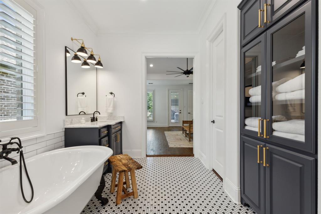 12444 Riverhill Road Frisco, TX 75033 - Photo 22 of 37 Master Bathroom with dual vanities, designer lighting, custom built-in linen cabinet with designer cabinet pulls.