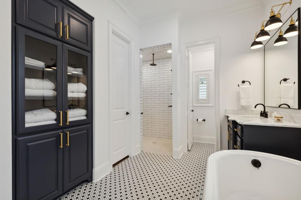 12444 Riverhill Road Frisco, TX 75033 - Photo 23 of 37 Master Bathroom with a tile shower, dual spray water features, ornamental molding, and tile floors.