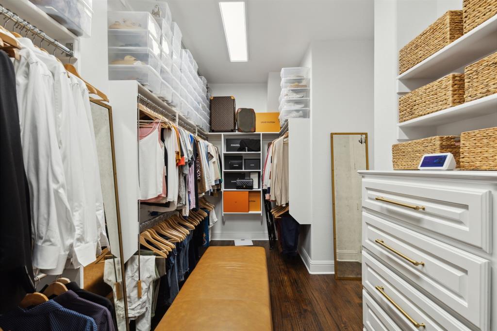 12444 Riverhill Road Frisco, TX 75033 - Photo 24 of 37 Large dual entry access Master walk in closet with hardwood floors and custom built-in drawers.