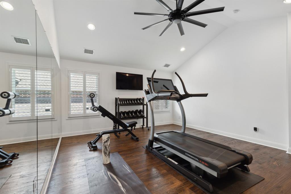12444 Riverhill Road Frisco, TX 75033 - Photo 31 of 37 Workout room with ceiling fan, hardwood flooring, plantation shutters and lofted ceiling