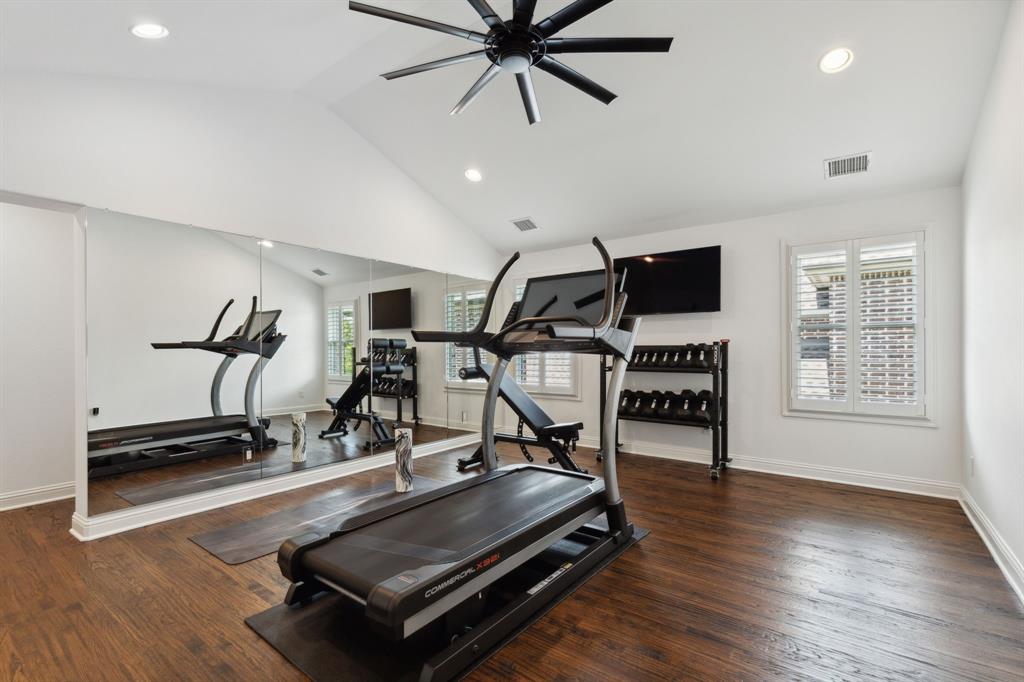 12444 Riverhill Road Frisco, TX 75033 - Photo 32 of 37 Exercise area with a wealth of natural light, vaulted ceiling, ceiling fan, and hardwood floors.