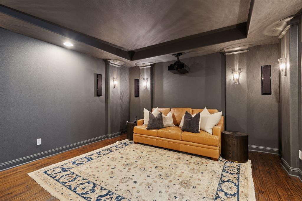 12444 Riverhill Road Frisco, TX 75033 - Photo 33 of 37 Home theater room with ornate columns, new media equipment, 120" movie screen and hardwood flooring.