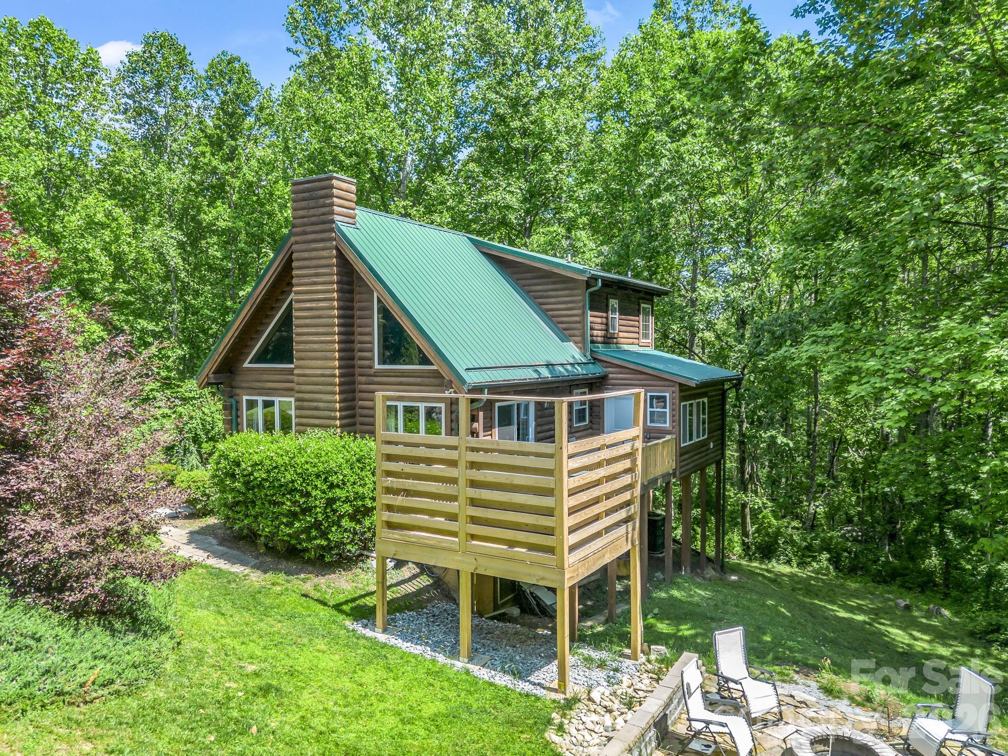 165 Dream Road Hendersonville, NC 28792 - Photo 42 of 46 a blue house with a yard potted plants and a table