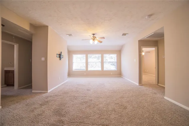 a view of a big room with windows and cabinet