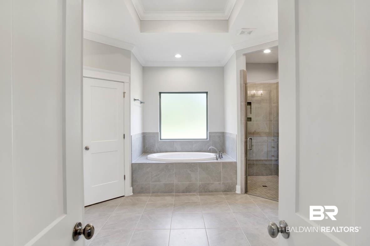 393 Garrison Boulevard Fairhope, AL 36532 - Photo 29 of 40 Bathroom with independent shower and bath, crown molding, and tile patterned floors