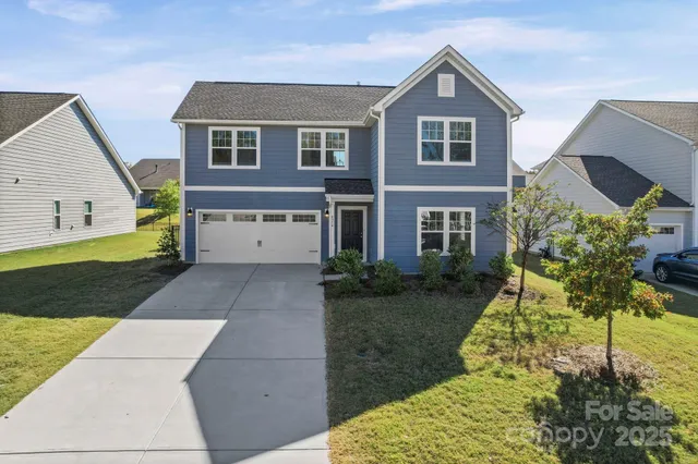 a view of empty room with wooden floor and ceiling fan