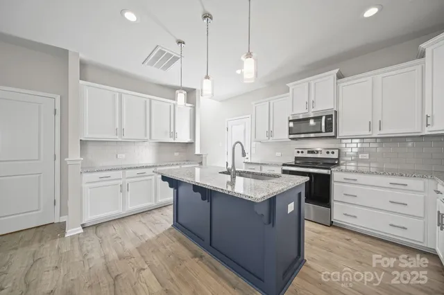 a kitchen with a sink window and cabinets
