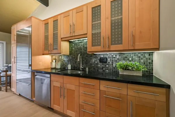 a kitchen with granite countertop a sink and cabinets