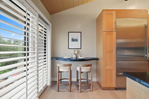 a kitchen with a sink refrigerator and cabinets