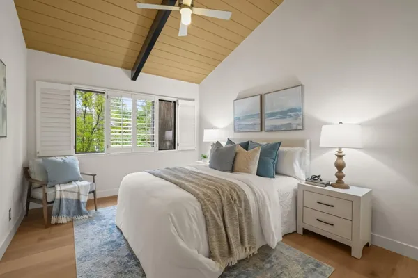 a bed room with bed and a chair