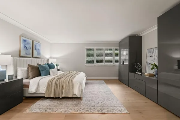 a bedroom with a bed and glass window