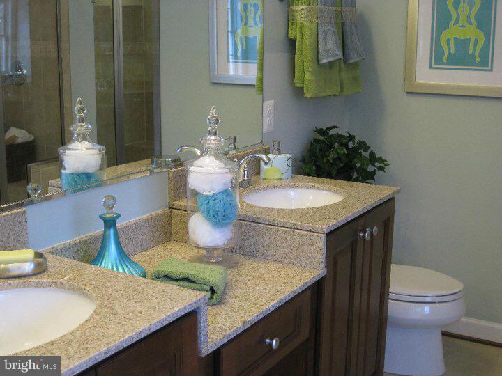 Rock Spring Forest Hill, MD 21050 - Photo 9 of 22 a bathroom with a granite countertop sink a toilet and a mirror