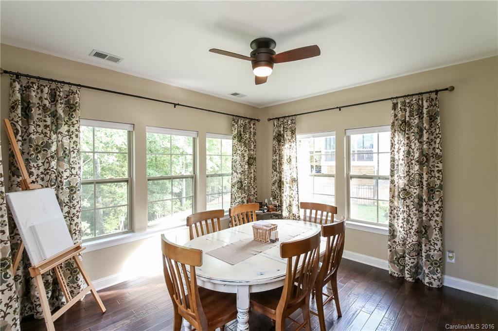 662 Reliance Court, Unit 13 Tega Cay, SC 29708 - Photo 14 of 24 a view of a dining room with furniture window and wooden floor