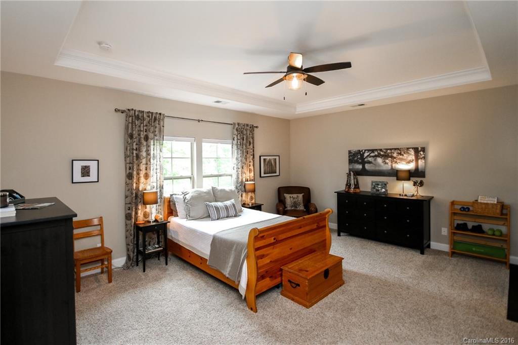 662 Reliance Court, Unit 13 Tega Cay, SC 29708 - Photo 15 of 24 a bedroom with a bed and a chandelier