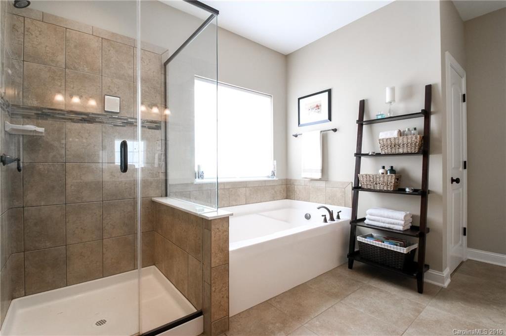 662 Reliance Court, Unit 13 Tega Cay, SC 29708 - Photo 16 of 24 a bathroom with a tub a sink and a shower