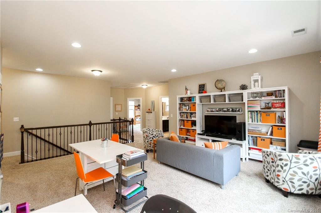 662 Reliance Court, Unit 13 Tega Cay, SC 29708 - Photo 18 of 24 a living room with furniture and a flat screen tv