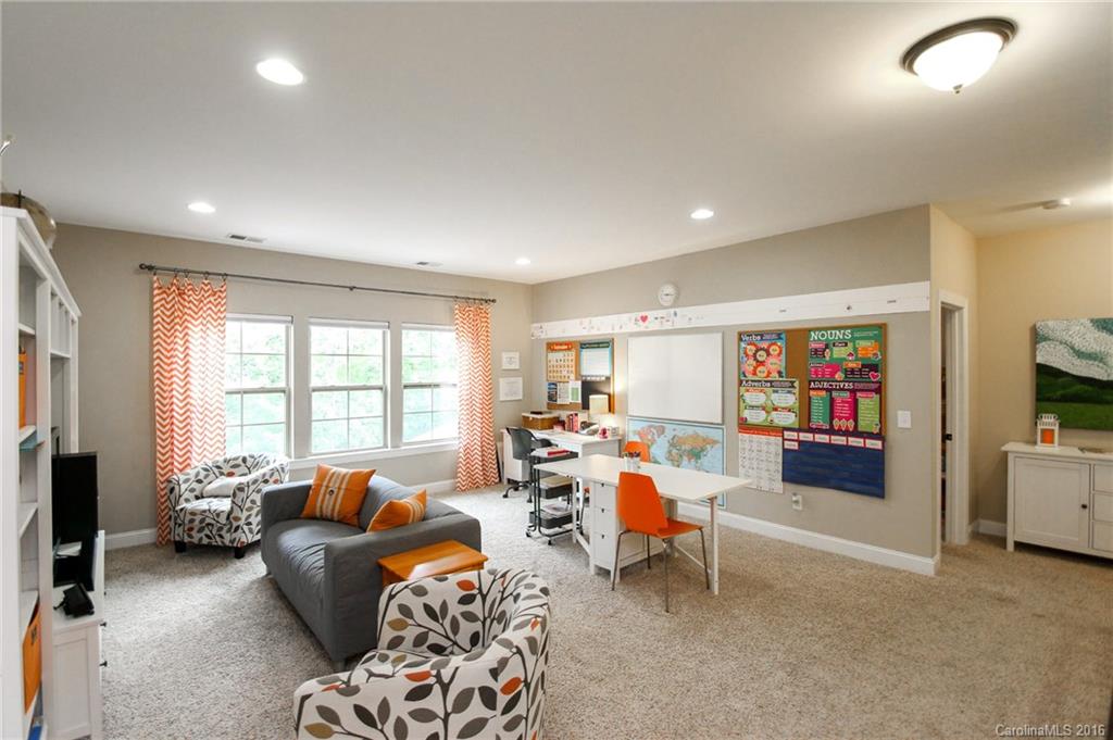 662 Reliance Court, Unit 13 Tega Cay, SC 29708 - Photo 19 of 24 a living room with furniture and a flat screen tv