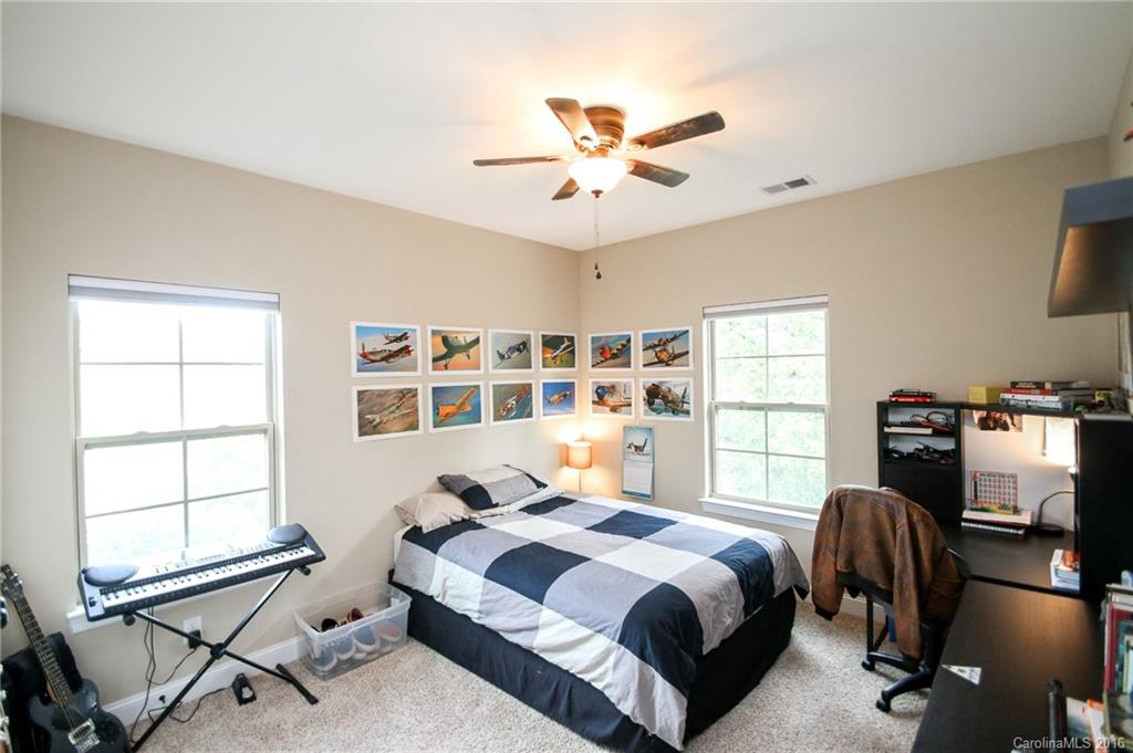 662 Reliance Court, Unit 13 Tega Cay, SC 29708 - Photo 20 of 24 a bedroom with a bed and a window