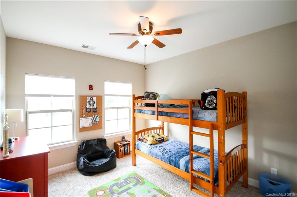 662 Reliance Court, Unit 13 Tega Cay, SC 29708 - Photo 21 of 24 a bedroom with furniture and a window