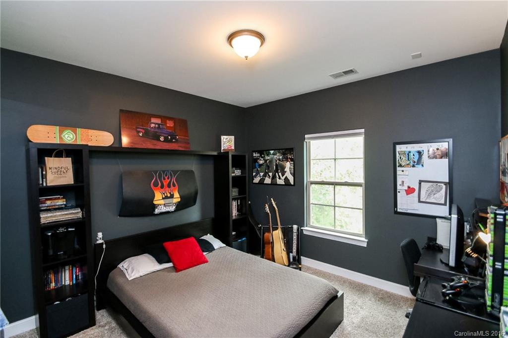 662 Reliance Court, Unit 13 Tega Cay, SC 29708 - Photo 23 of 24 a living room with furniture a flat screen tv and a fireplace