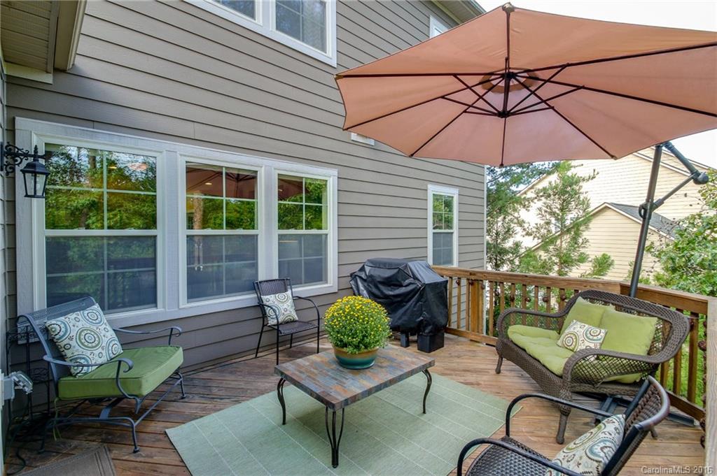 662 Reliance Court, Unit 13 Tega Cay, SC 29708 - Photo 24 of 24 a view of a balcony with furniture and umbrella