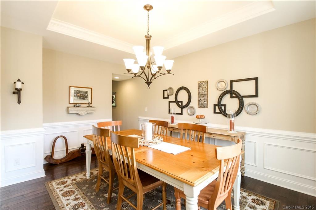 662 Reliance Court, Unit 13 Tega Cay, SC 29708 - Photo 4 of 24 a dining room with furniture a chandelier and wooden floor