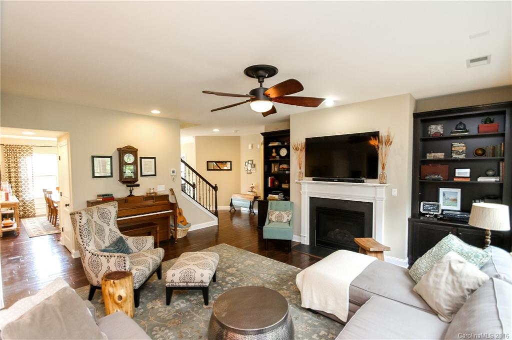 662 Reliance Court, Unit 13 Tega Cay, SC 29708 - Photo 8 of 24 a living room with furniture a flat screen tv and a fireplace
