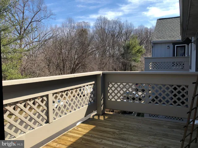a view of an empty room fire place and a refrigerator