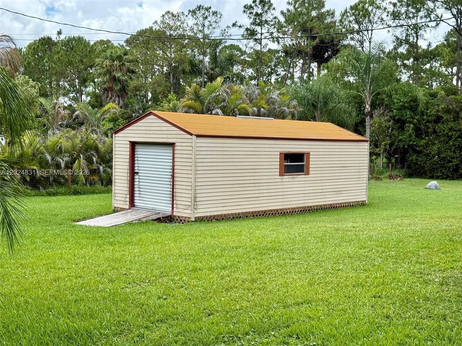 15819 76th Road North Loxahatchee, FL 33470 - Photo 7 of 45 a view of a backyard with a garden