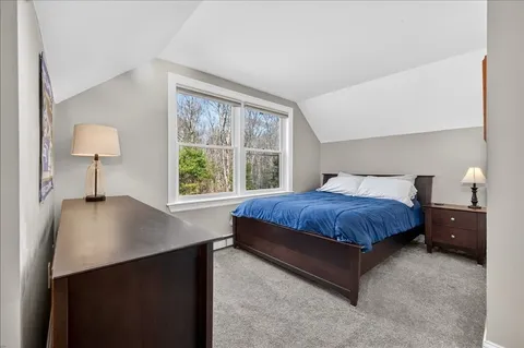 a bedroom with a bed and a lamp on table