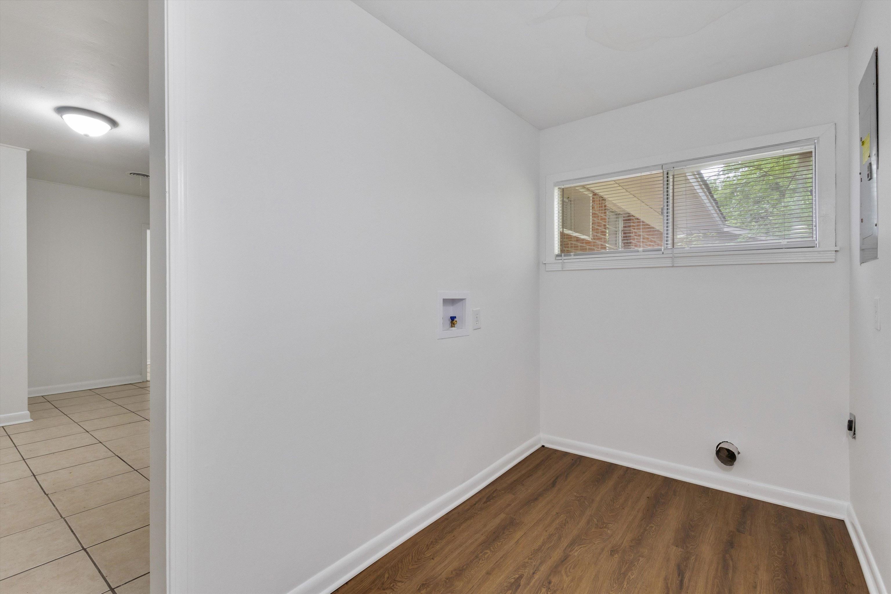 4565 Verne Road Memphis, TN 38117 - Photo 9 of 18 Utility room featuring wood-finish flooring, white walls, and a multi-pane window
