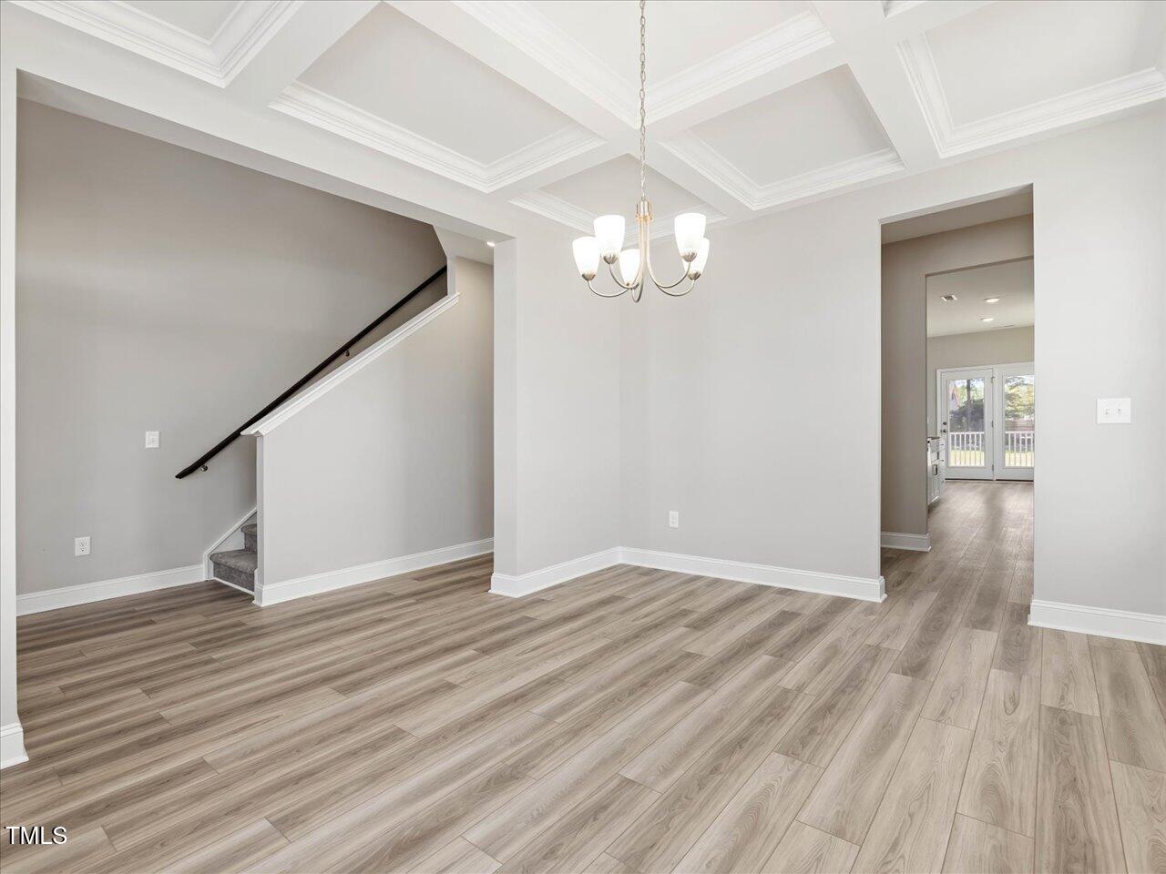 63 Biscayne Court Angier, NC 27501 - Photo 11 of 52 an empty room with wooden floor chandelier and entryway