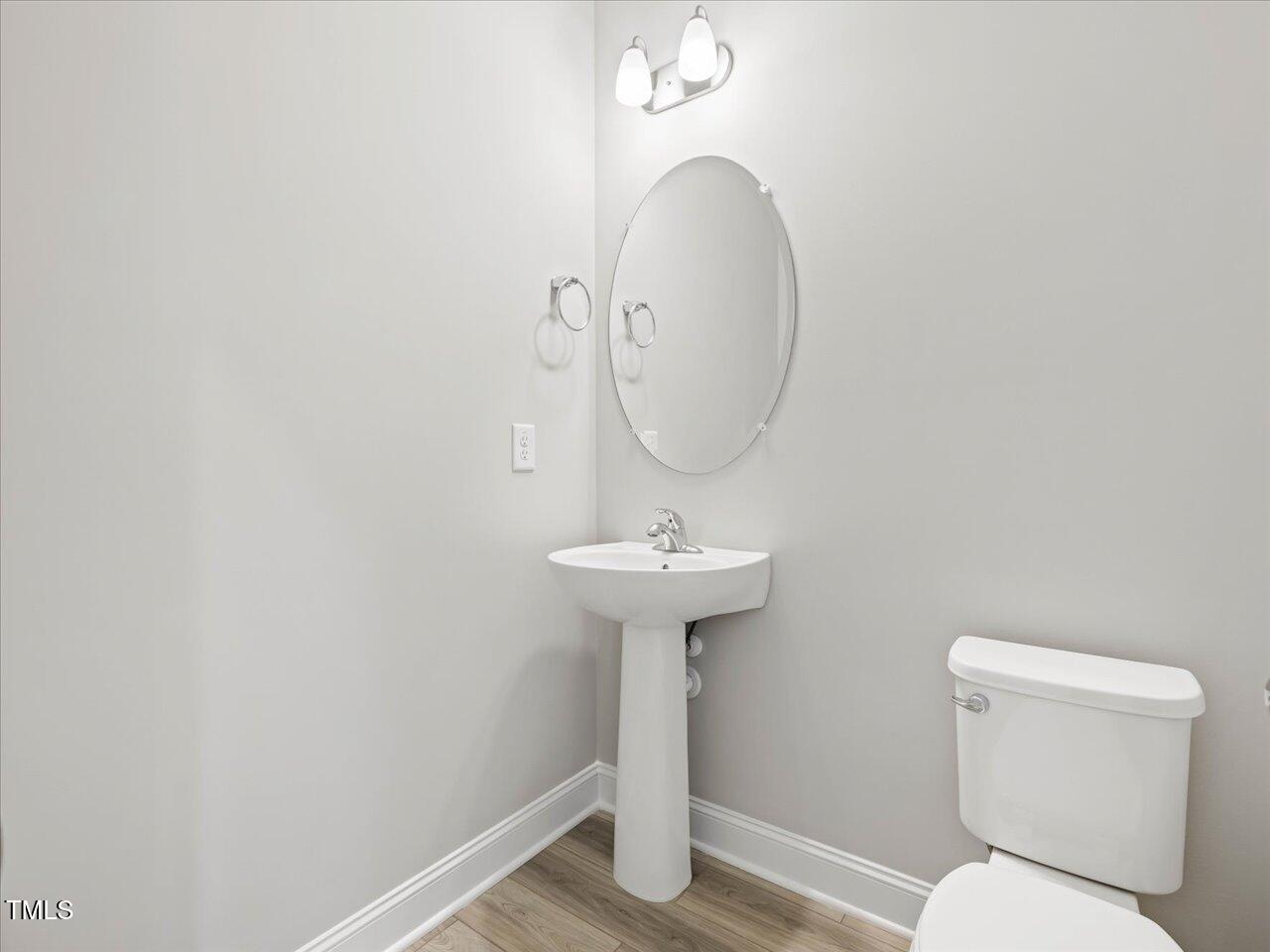 63 Biscayne Court Angier, NC 27501 - Photo 14 of 52 a bathroom with a toilet a sink and a mirror