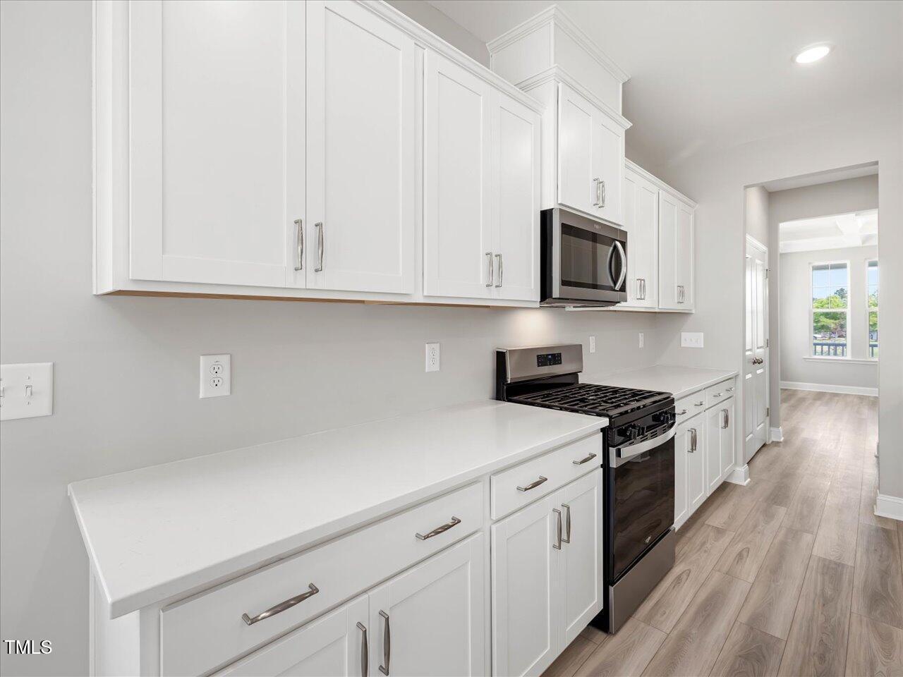 63 Biscayne Court Angier, NC 27501 - Photo 22 of 52 a kitchen with granite countertop white cabinets and white appliances