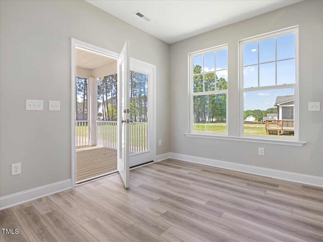 63 Biscayne Court Angier, NC 27501 - Photo 27 of 52 a view of an empty room with wooden floor and windows
