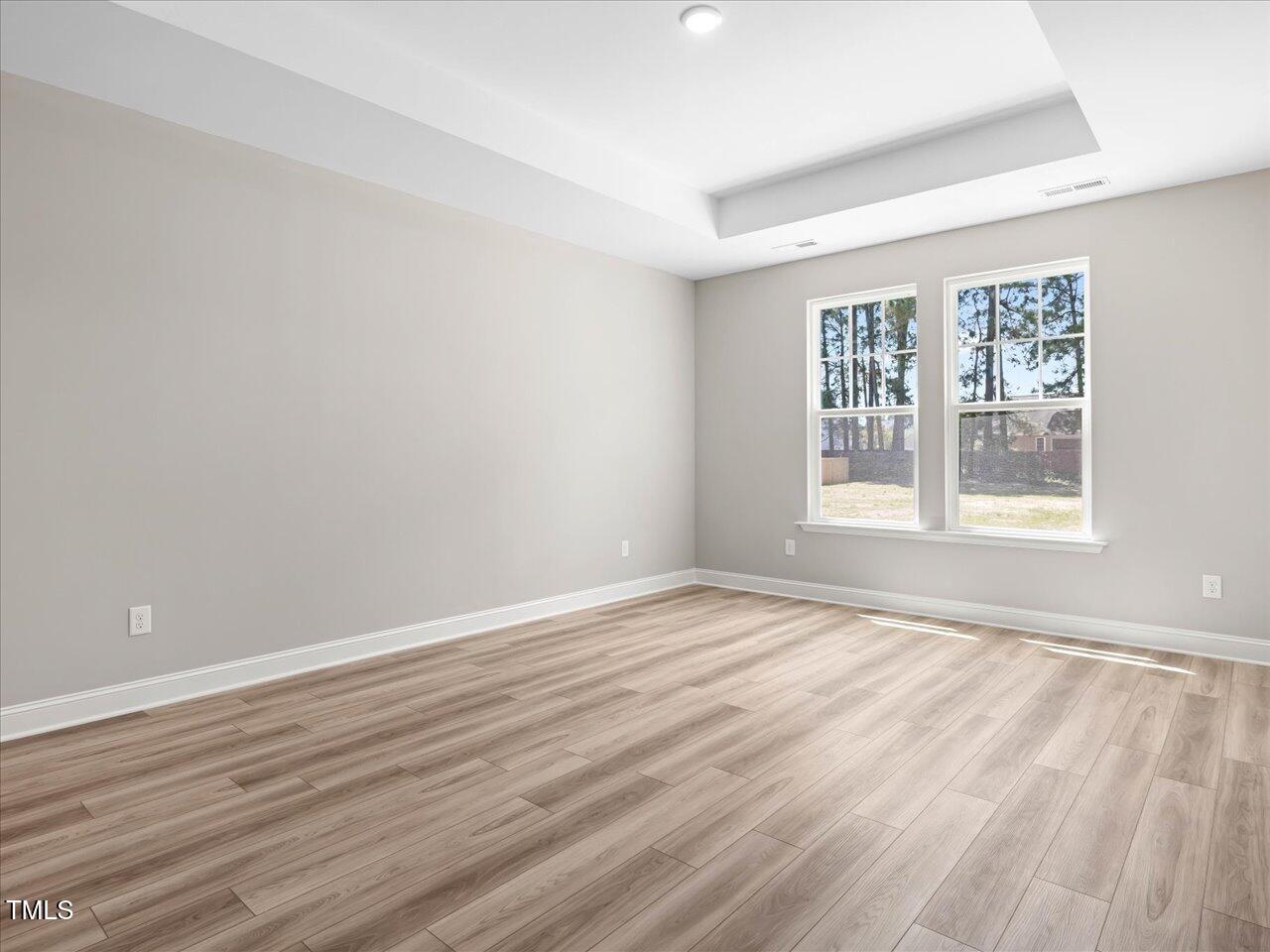 63 Biscayne Court Angier, NC 27501 - Photo 30 of 52 a view of an empty room with wooden floor and a window
