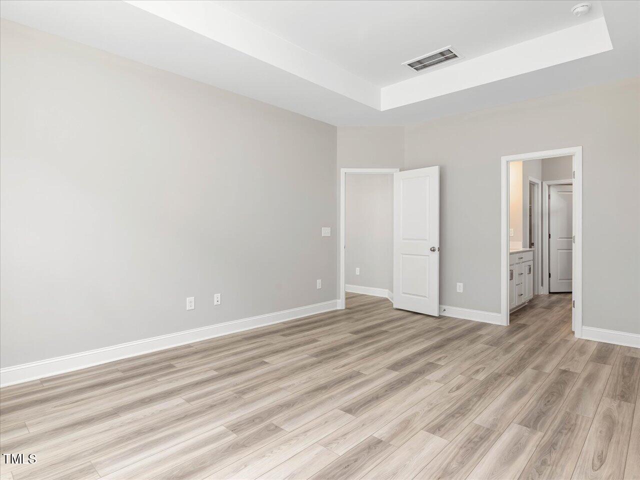 63 Biscayne Court Angier, NC 27501 - Photo 31 of 52 a view of an empty room with wooden floor