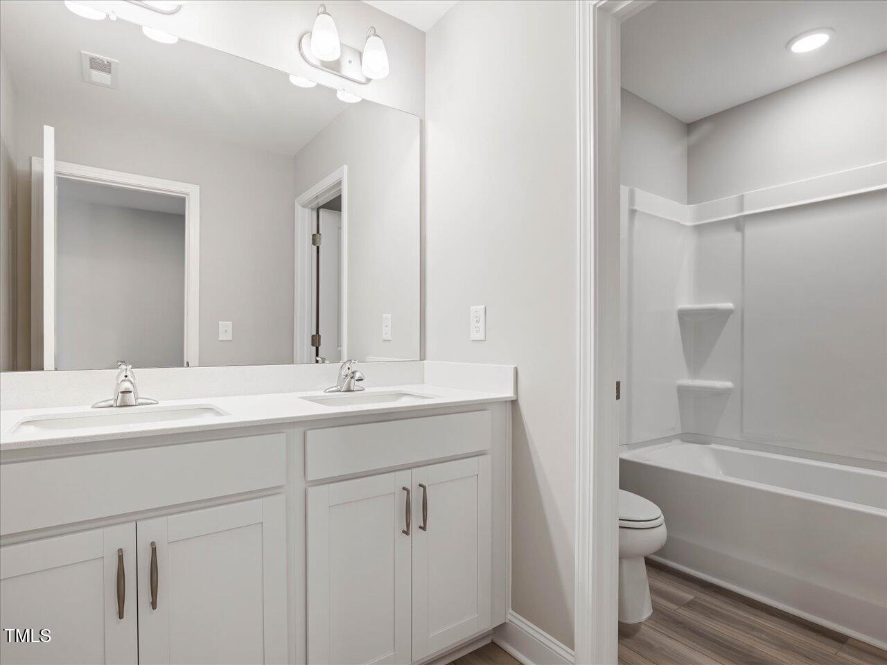 63 Biscayne Court Angier, NC 27501 - Photo 47 of 52 a bathroom with a sink a toilet and shower